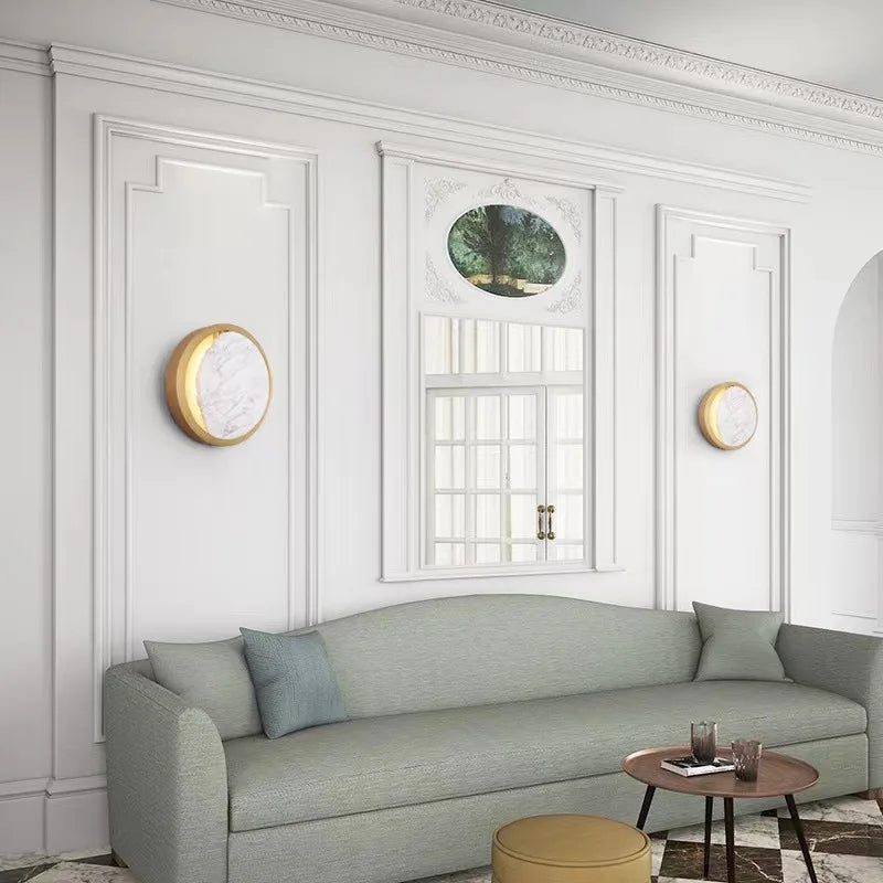 Gray sofa in a stylish living room with white walls and decorative elements.
