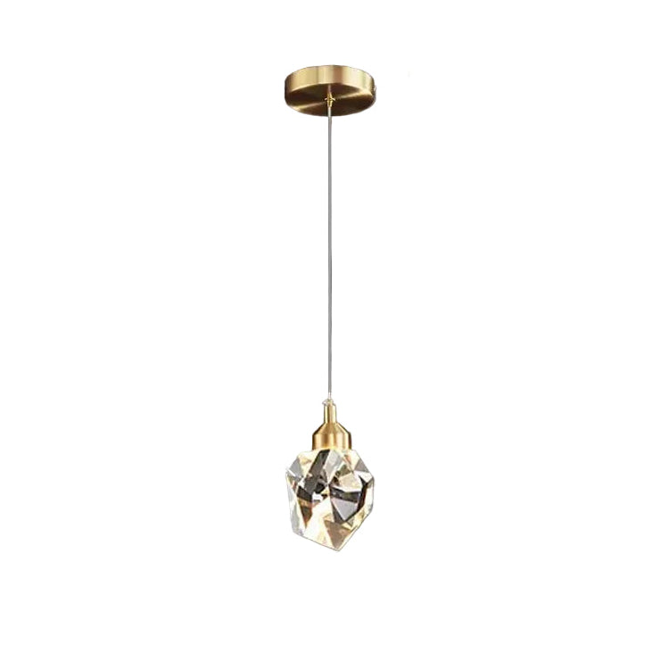 Gold pendant light with crystal and measurements on a dark background