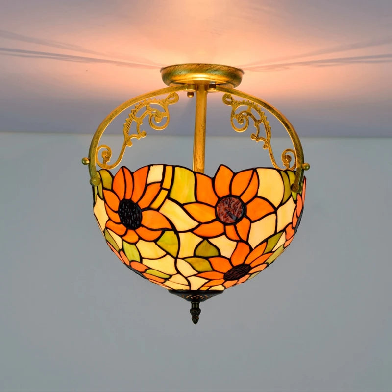 Decorative ceiling light with floral stained glass design on a plain background