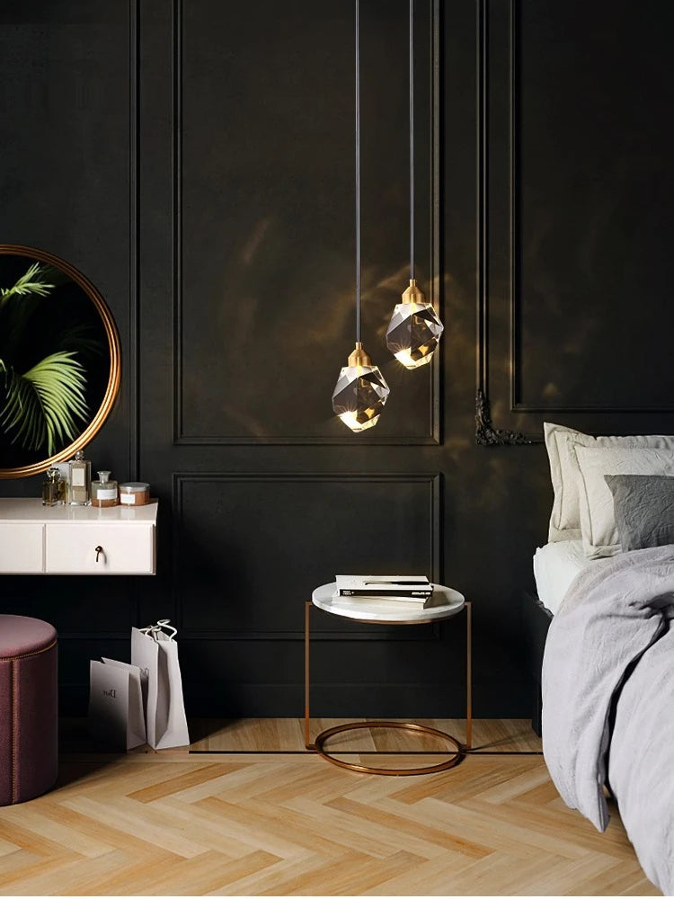 Modern bedroom with dark walls, pendant lights, and a bed.