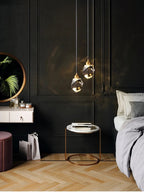 Modern bedroom with dark walls, pendant lights, and a bed.