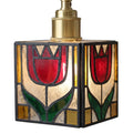 A vintage-style stained glass pendant light featuring two red tulips with green leaves inside a square frame, with a brass-colored metal neck at the top, shown against a solid gray background.