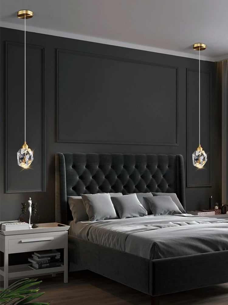 Modern bedroom with dark gray walls, a tufted bed, and decorative pendant lights.