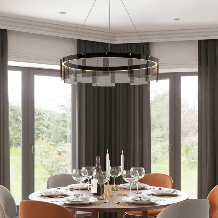 Dining room with a modern chandelier, table set for dinner, and large windows.