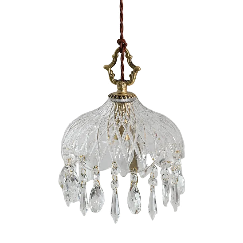 Small crystal chandelier with decorative elements on a plain background