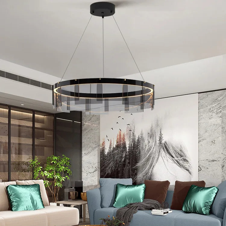 Modern living room with a stylish chandelier, comfortable sofa, and decorative pillows.