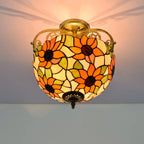 Decorative ceiling light with floral stained glass design on a plain background