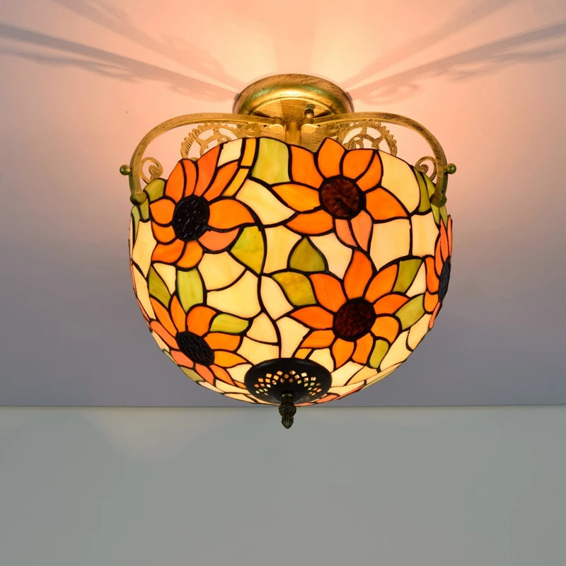 Decorative ceiling light with floral stained glass design on a plain background