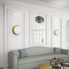 Gray sofa in a stylish living room with white walls and decorative elements.
