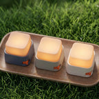 Three hexagonal night lights on a wooden tray with a blurred background