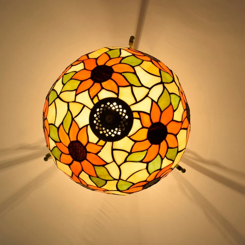 Decorative stained glass lamp with sunflower pattern on a beige background