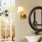 Wall-mounted lamp in a bathroom setting with a mirror and window.