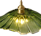 Green lampshade with gold fixture on a white background