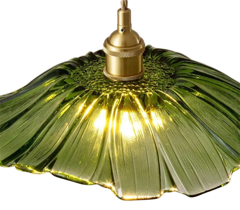 Green lampshade with gold fixture on a white background