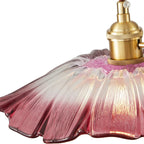 Pink glass lampshade with gold fixture on a white background