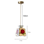 Stained glass pendant light with rose design and dimensions on a white background