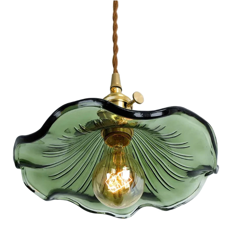 Green glass pendant light with a lit bulb on a white background