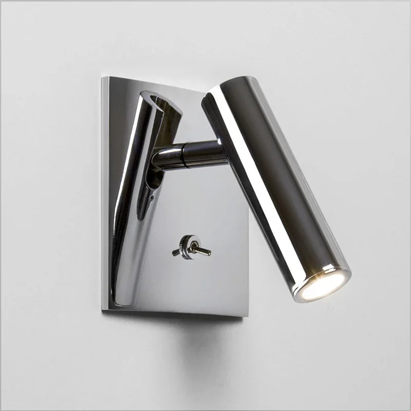 Chrome wall-mounted light fixture on a gray background
