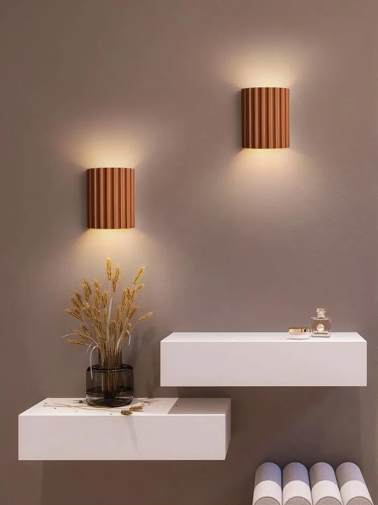 Modern wall lights with a minimalistic setup on a gray wall.