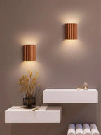 Modern wall lights with a minimalistic setup on a gray wall.