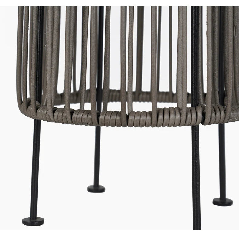 Wicker floor lamp with metal legs on a white background